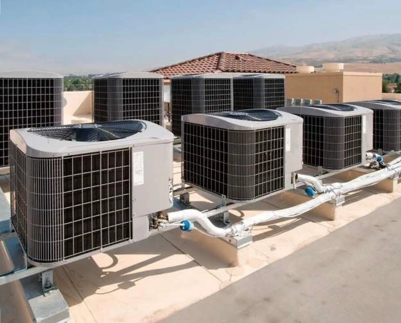 Outdoor air-conditioning units and piping at the training camp accommodation, Al Watba